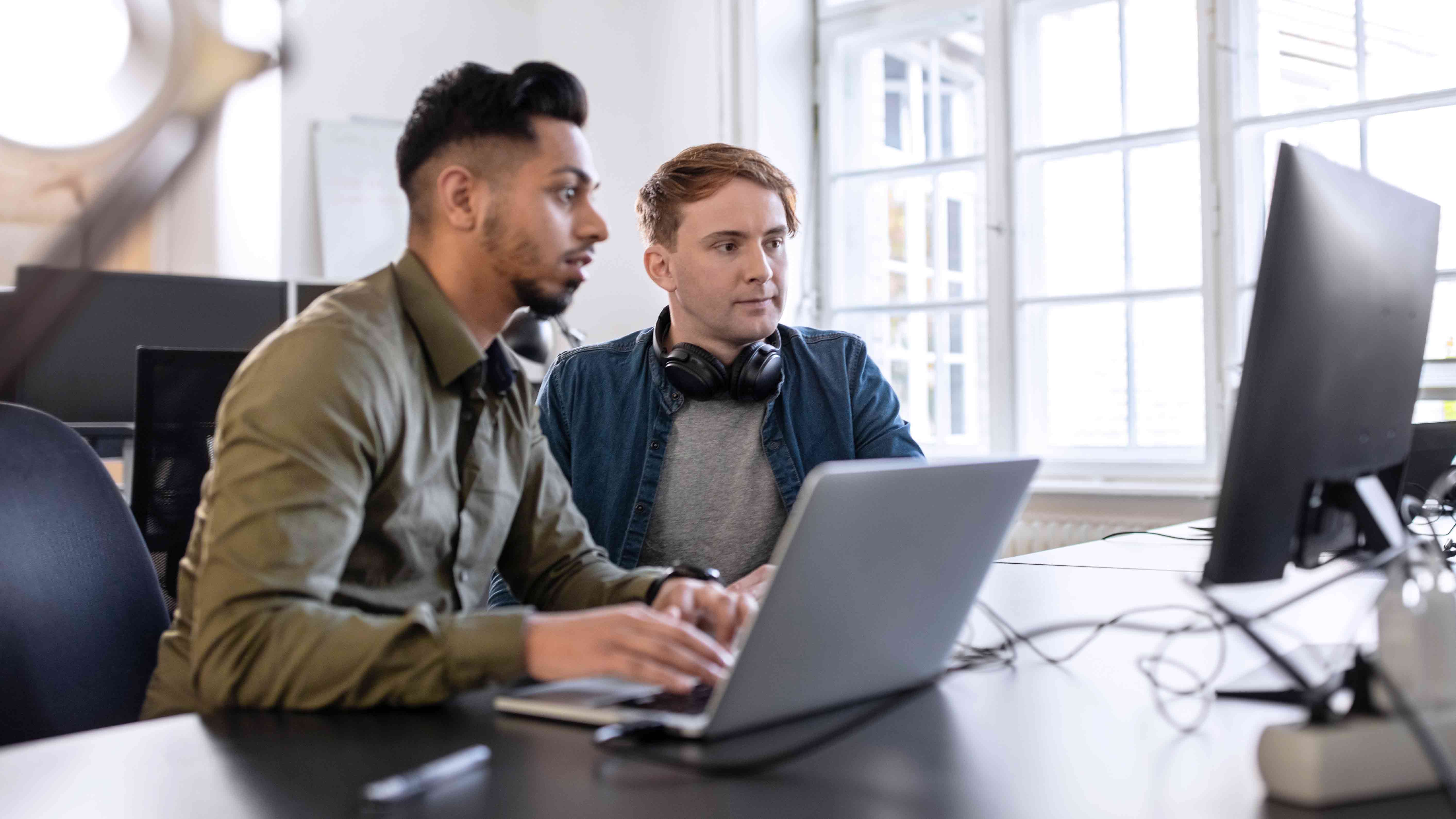 Two developers work at a computer