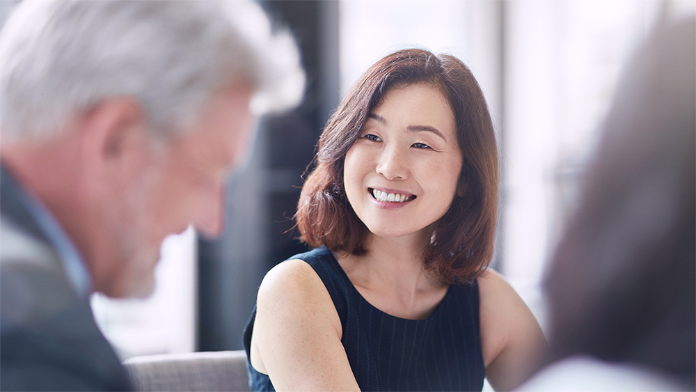 Image of woman speaking to man.