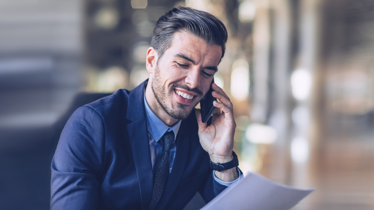 Business man laughing into his phone 