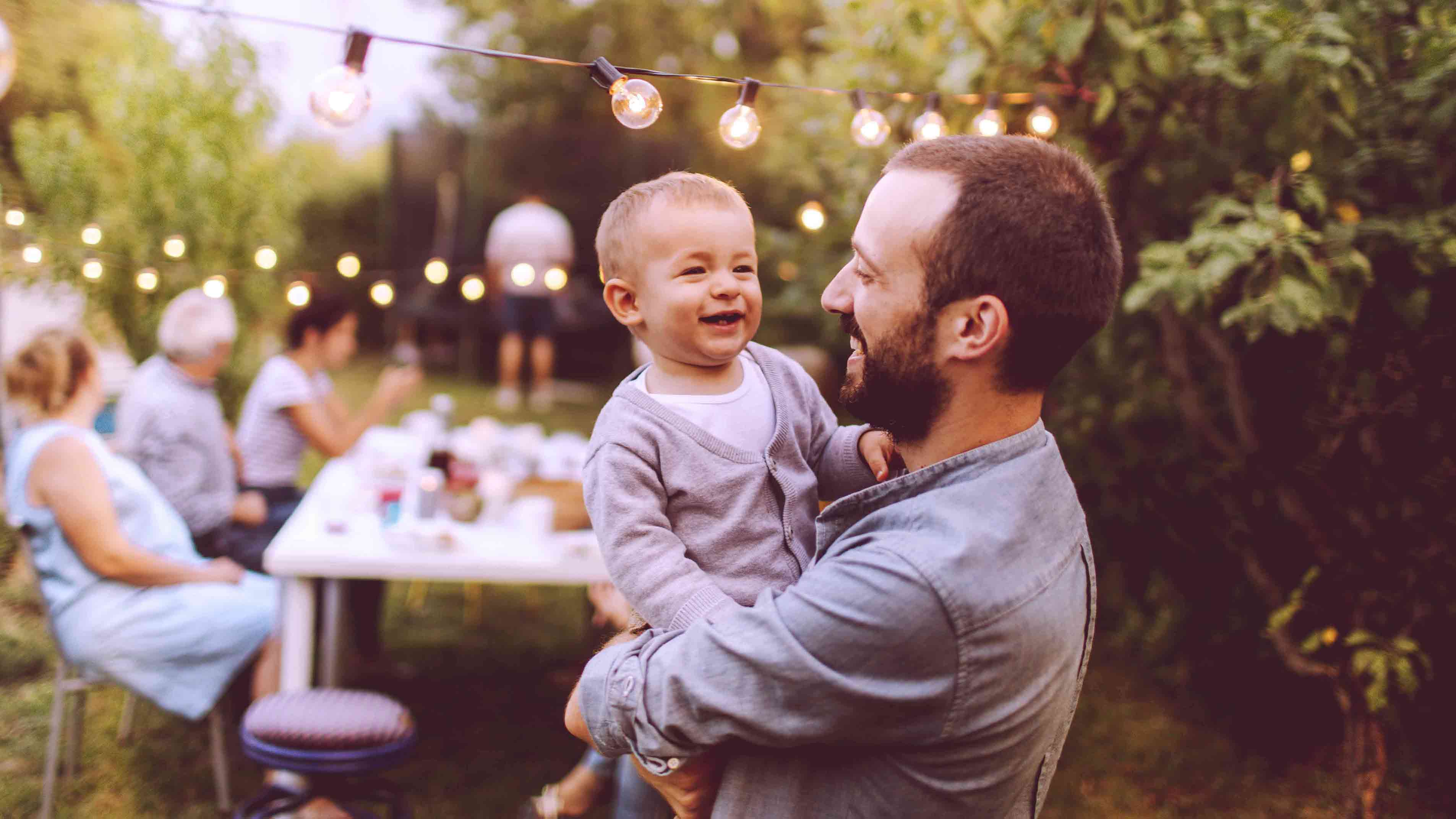 Smiling man with child on his back